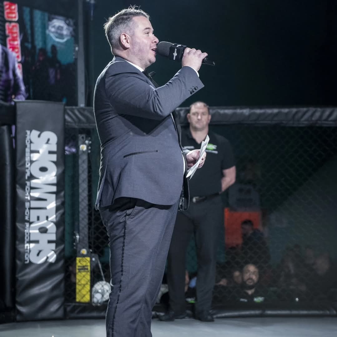 Jonathan Millard announcing inside the MMA cage at a Showtechs event